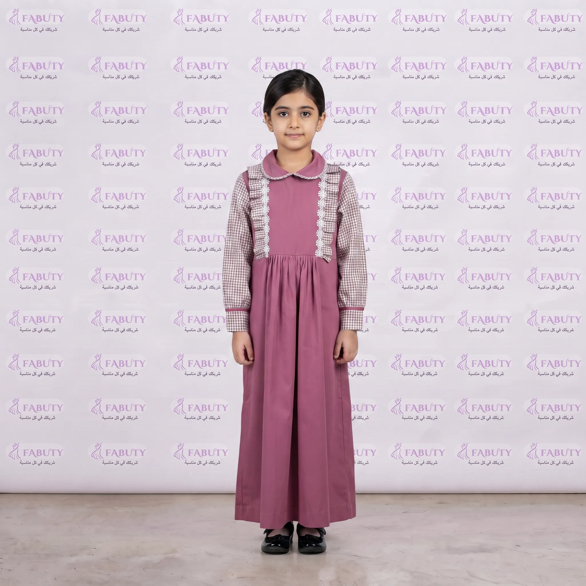 Model_wearing_dress_with_logo_202607311809 مريول مدرسي كويتي وردي ابتدائي - الصورة 1